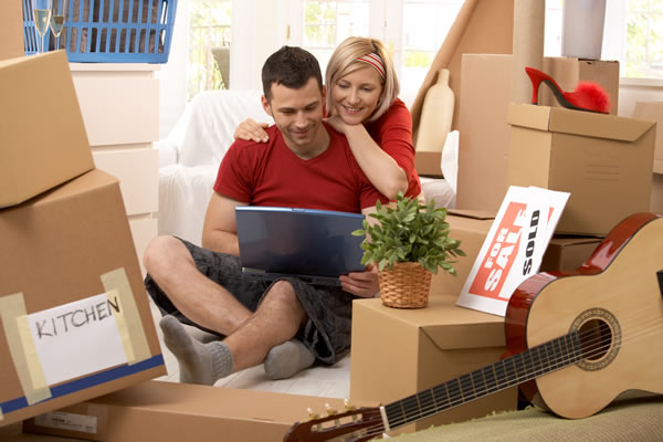 Image of young couple amongst moving boxes.